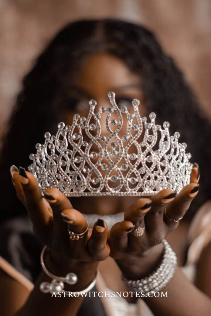 A woman is holding a crown -represents the symbol of a Leo sign.